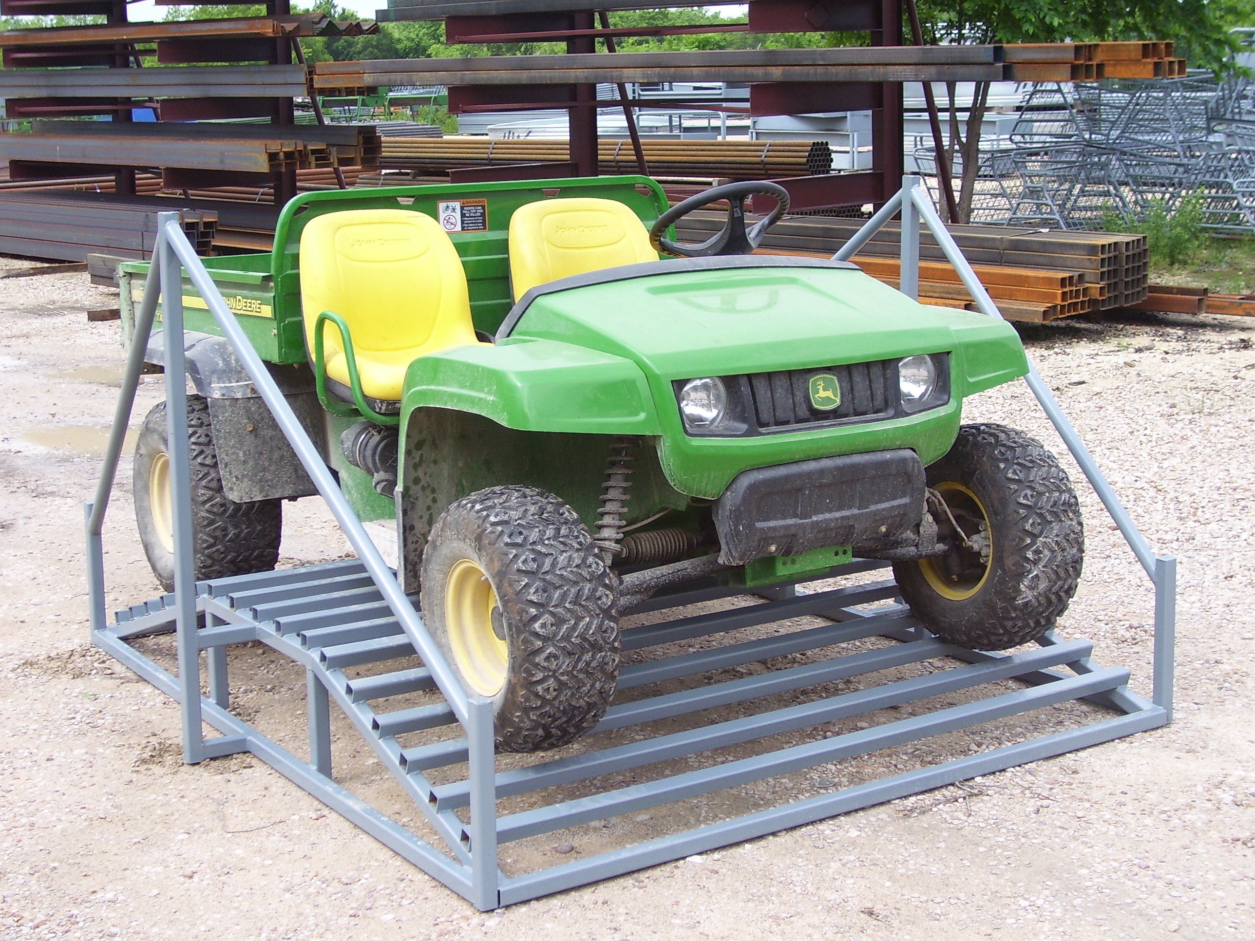 An ATV sitting on a cattle guard designed to be set in a fence line so UTV can cross while keepng livestock contained.