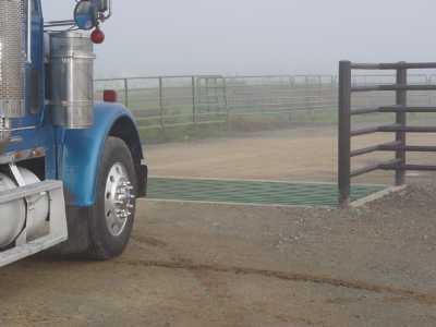 A truck crossing over a cattle guard