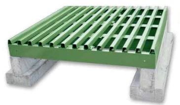 A cattle guard sitting on top of precast concrete foundations,
