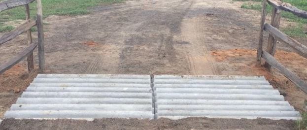 A finished concrete cattle guard crossing.