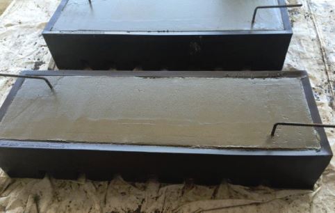 A cattle guard form filled with cement.